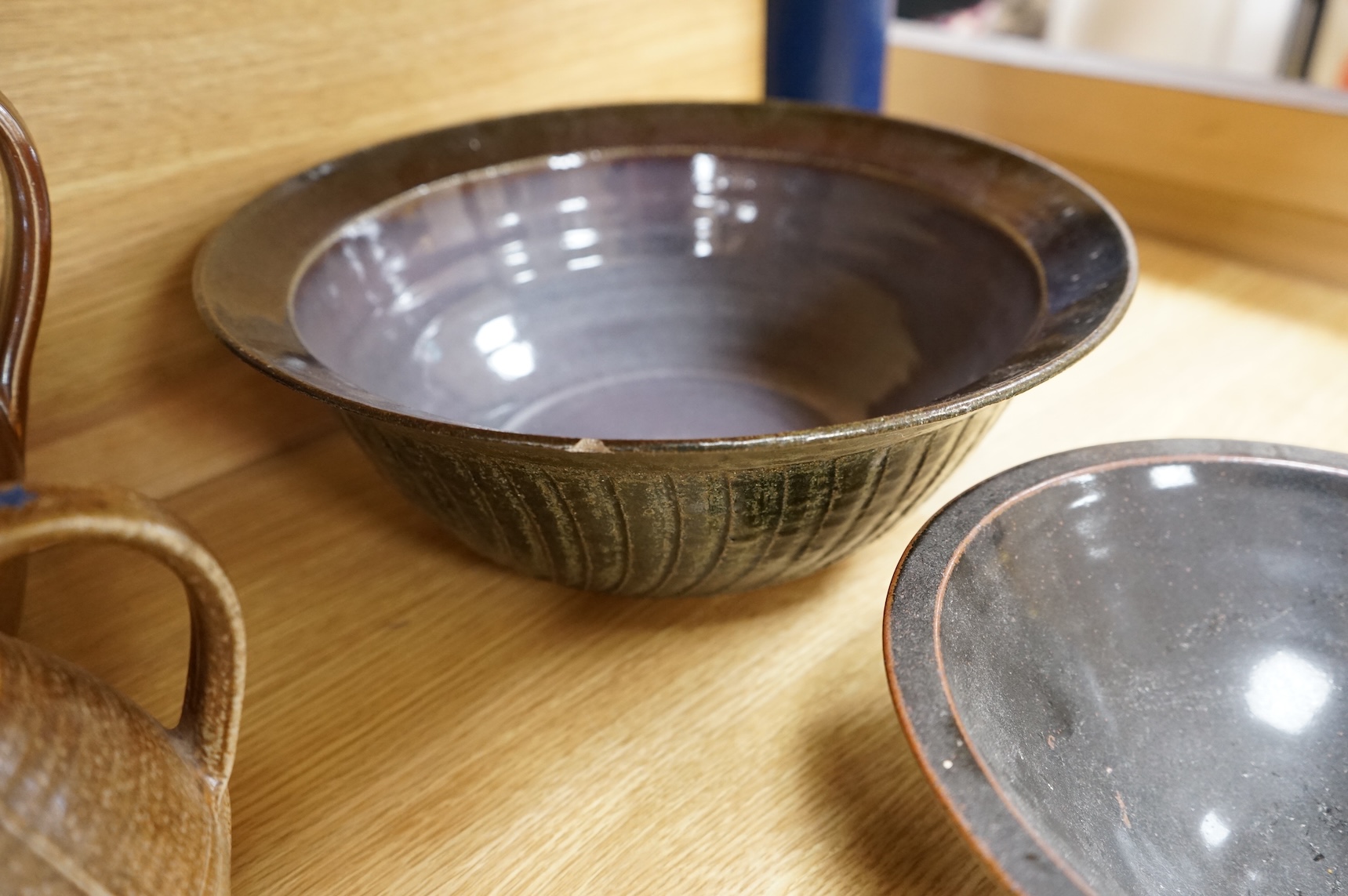 A Poole pottery Aegean dish, together with a selection of Studio pottery bowls, dishes, jugs etc and a Donoghue / Rye cottage model, Poole dish 20cm diameter (14)